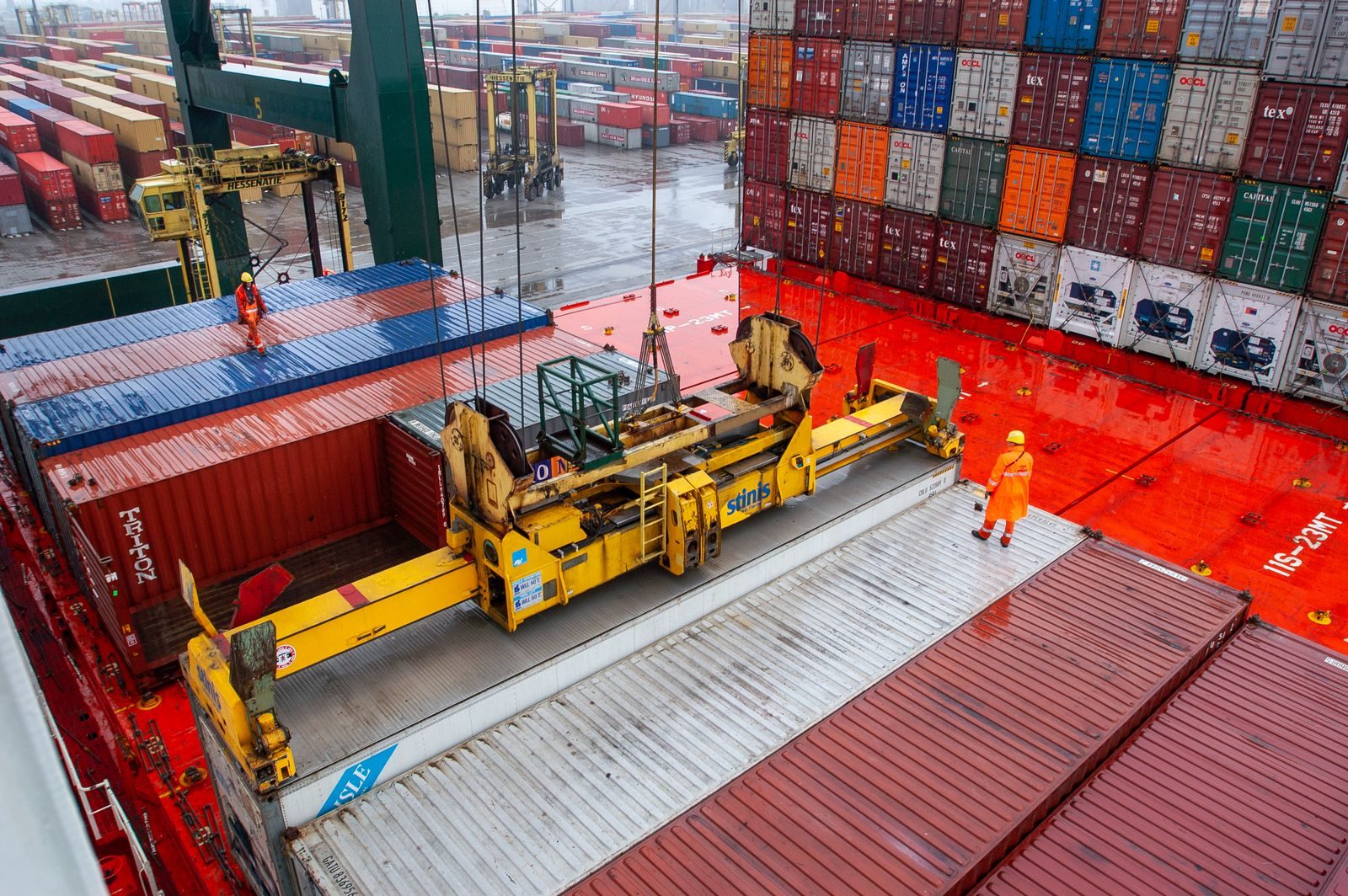 A gantry crane lifting a container.