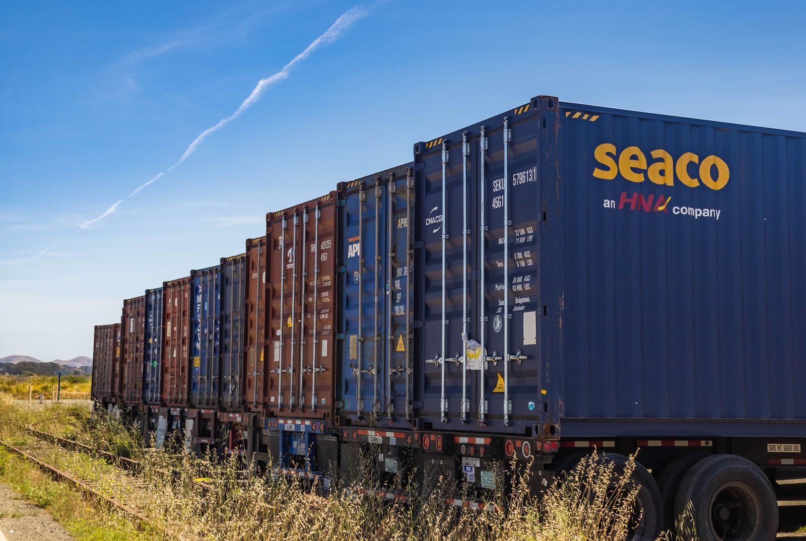 A freight train loaded with shipping containers.