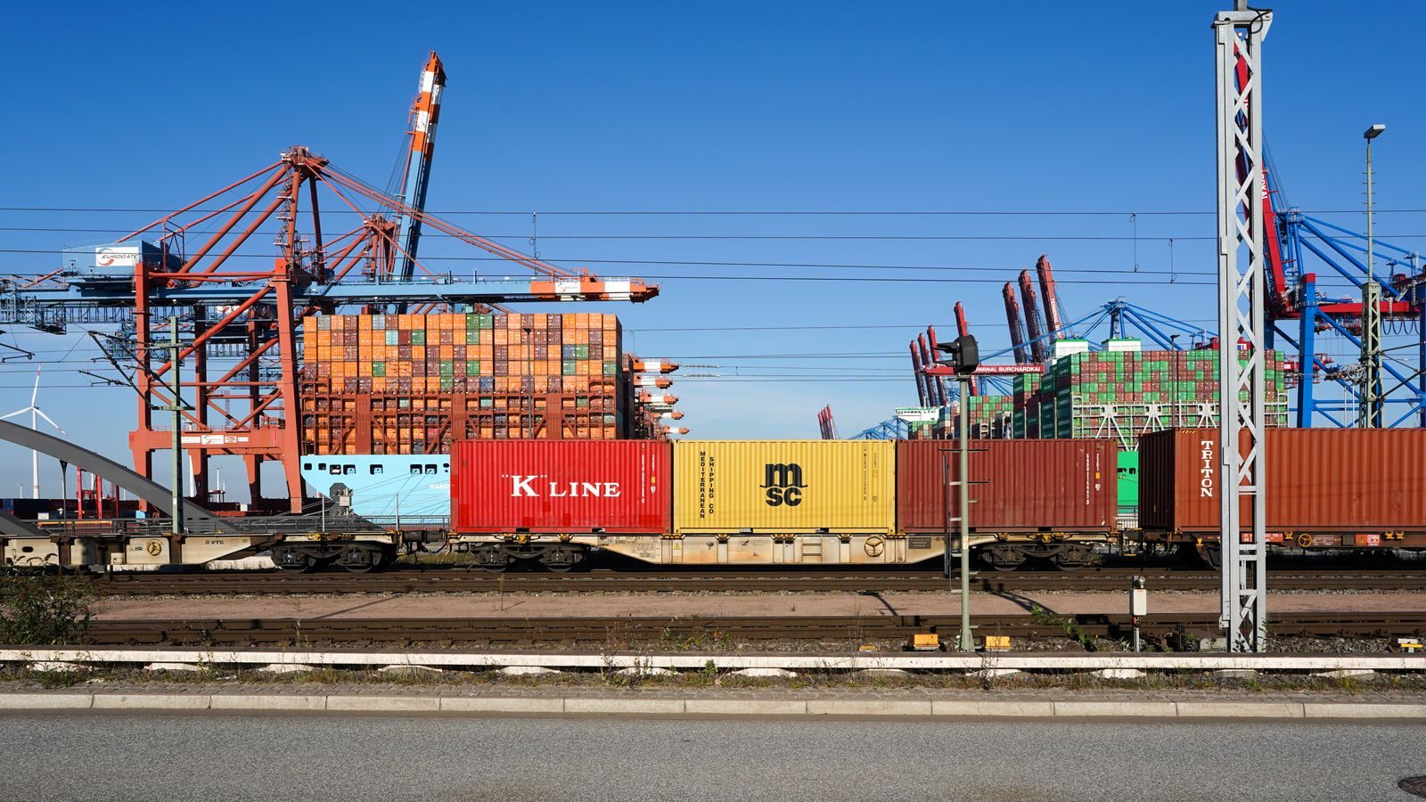 A rail container terminal with gantry cranes moving containers.