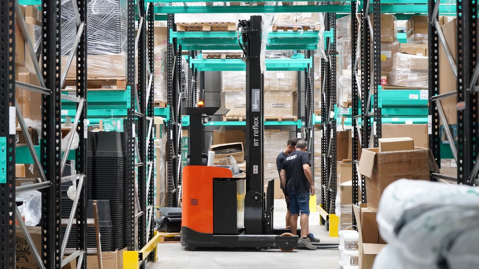 A forklift working in warehouse racking.